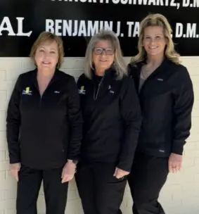 First Care Dental team members Alice, Lisa, and Misty standing together in front of the Louisville office.